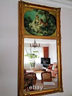 Carved wooden trumeau mirror adorned with an oil on canvas countryside landscape