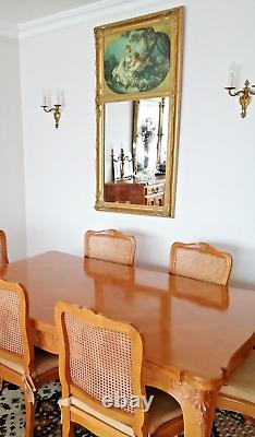 Carved wooden trumeau mirror adorned with an oil on canvas countryside landscape