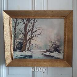 Oil on canvas signed Winter landscape under snowy river edge woods