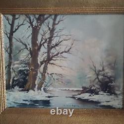 Oil on canvas signed Winter landscape under snowy river edge woods