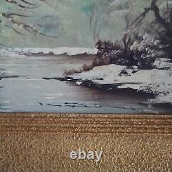 Oil on canvas signed Winter landscape under snowy river edge woods