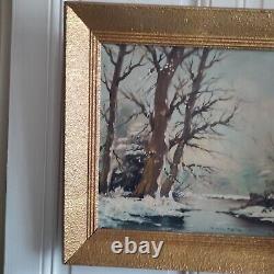 Oil on canvas signed Winter landscape under snowy river edge woods