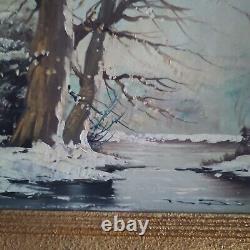 Oil on canvas signed Winter landscape under snowy river edge woods