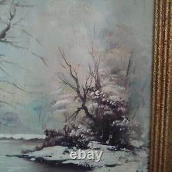 Oil on canvas signed Winter landscape under snowy river edge woods