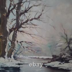 Oil on canvas signed Winter landscape under snowy river edge woods