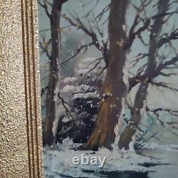 Oil on canvas signed Winter landscape under snowy river edge woods