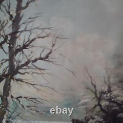 Oil on canvas signed Winter landscape under snowy river edge woods