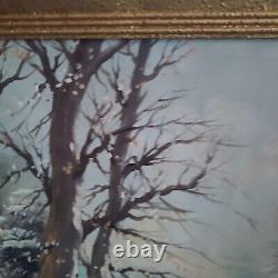 Oil on canvas signed Winter landscape under snowy river edge woods