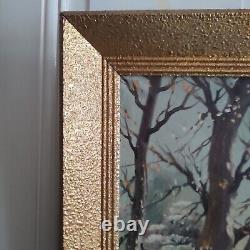 Oil on canvas signed Winter landscape under snowy river edge woods