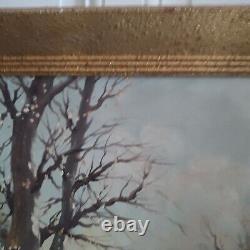 Oil on canvas signed Winter landscape under snowy river edge woods
