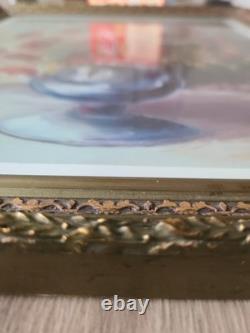 Old carved wooden frame with a reproduction of an oil on canvas signed